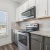 kitchen with two tone cabinets and a window