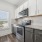 kitchen with two tone cabinets and a window