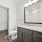 bathroom with a mirror and attached closet
