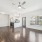 living area with windows and a ceiling fan