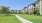 outdoor sidewalk with grass and buildings surrounding