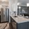 a kitchen with a stainless steel refrigerator